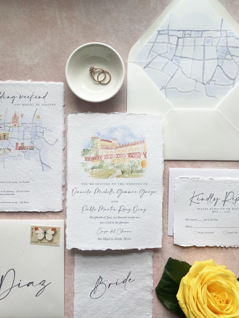 watercolor wedding invitation suite on a pink background with a map of san miguel de allende
