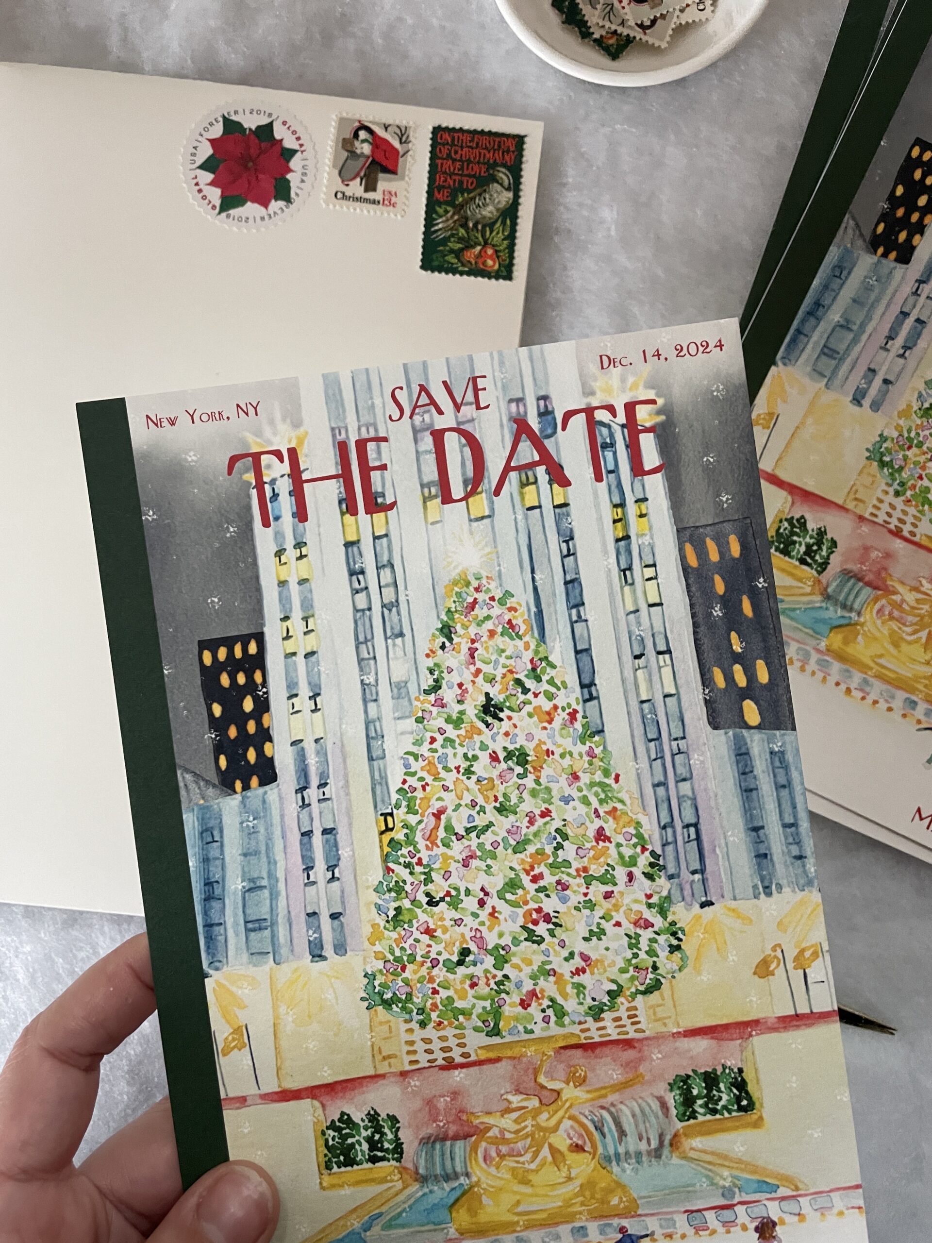 christmas save the date with watercolor painting and vintage holiday postage featuring a poinsettia, mailbox, and bird